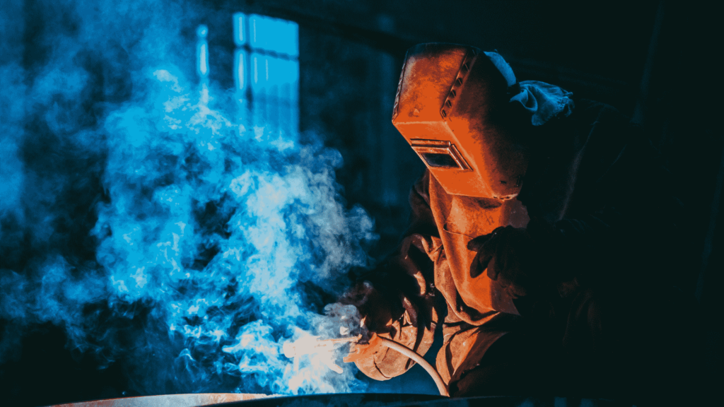 worker with a welding machine working on a piece